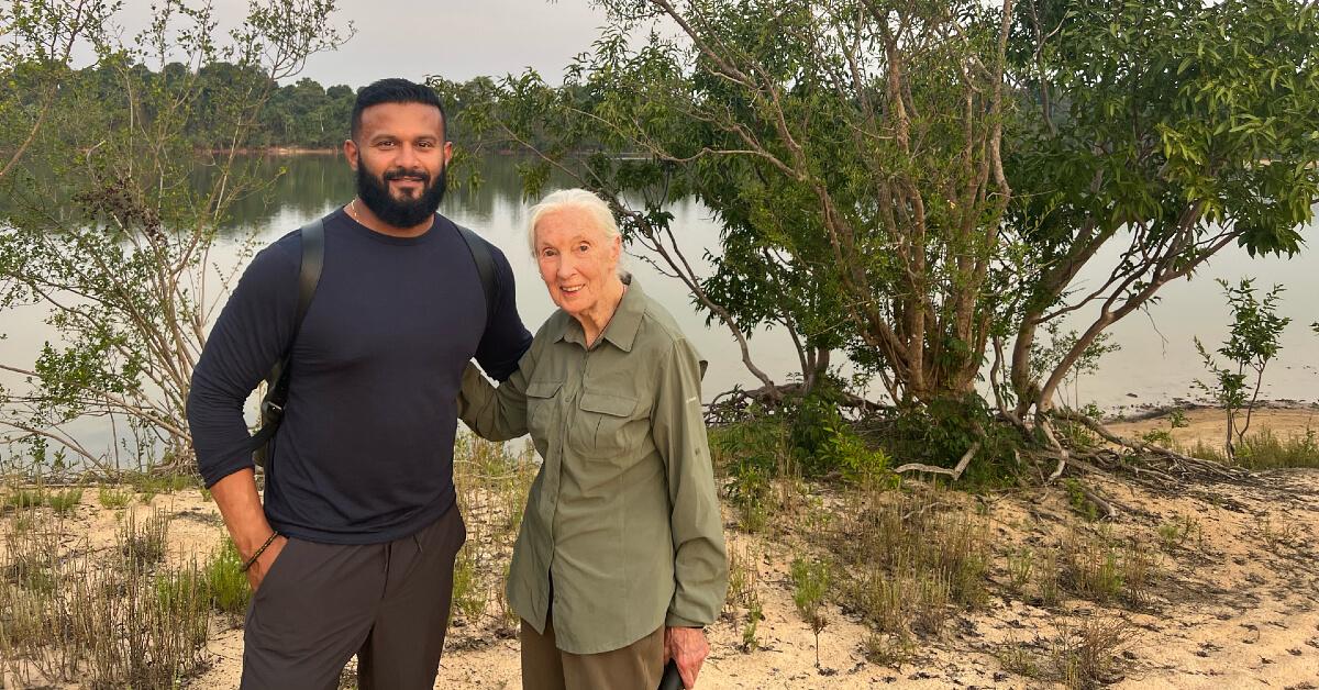 Dax Dasilva and Dr. Jane Goodall standing in front of a body of water