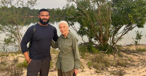 Dax Dasilva and Dr. Jane Goodall standing in front of a body of water