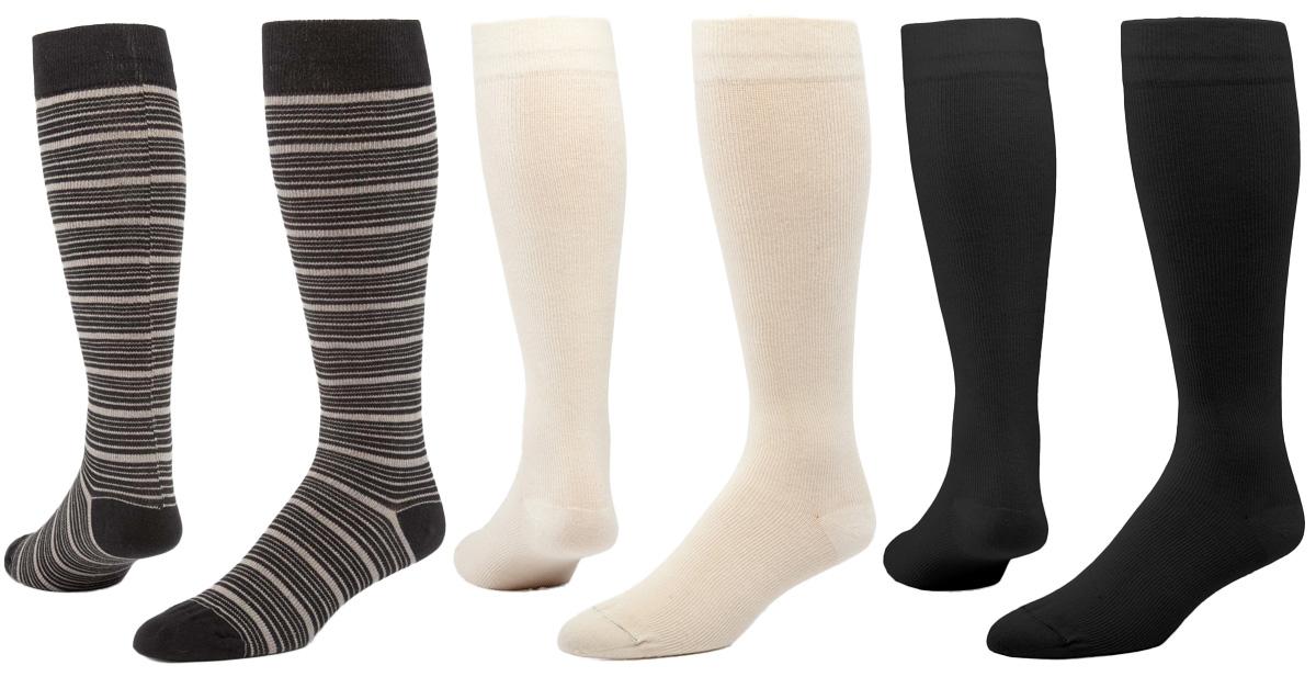 three pairs of knee-high compression socks: cream, white, and striped