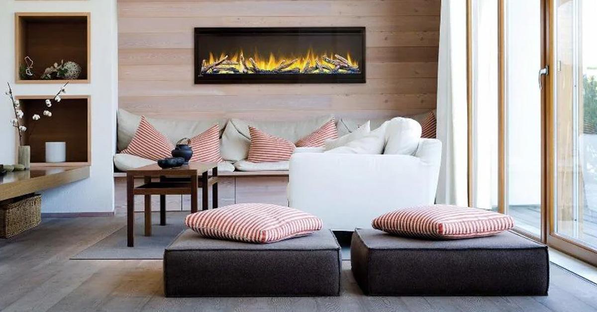 a built-in electric fireplace in a room with seating and pillows