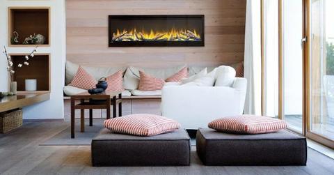 a built-in electric fireplace in a room with seating and pillows