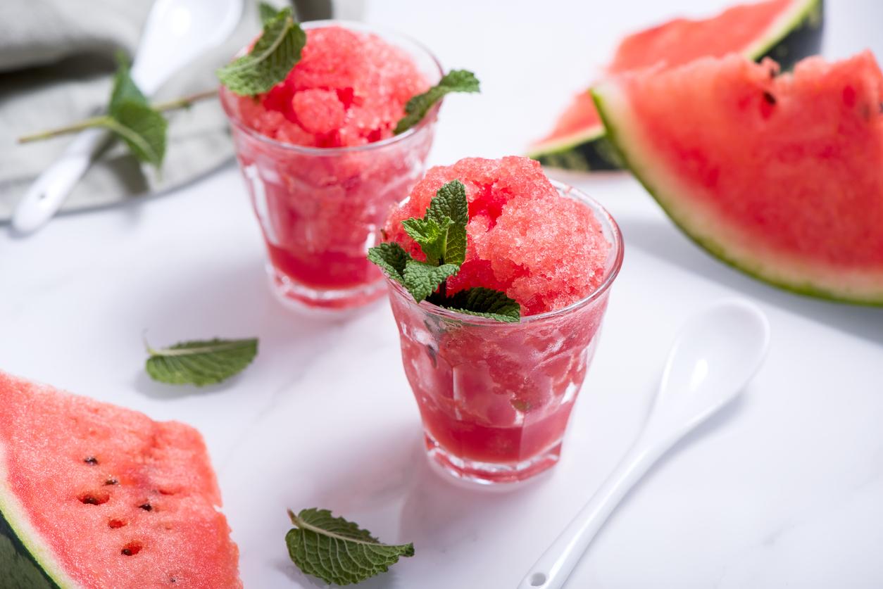 Frozen watermelon drink in a small glass with mint.