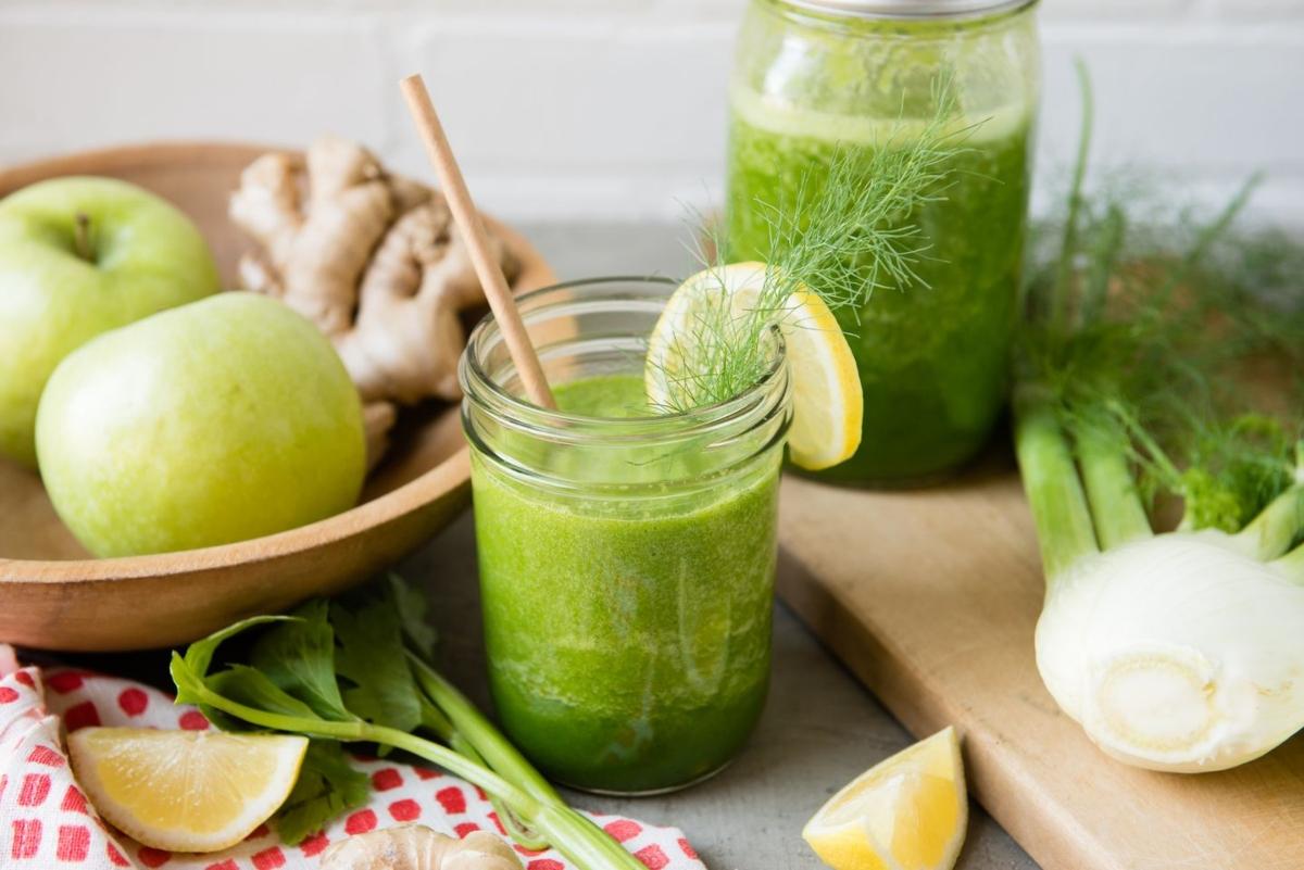 ingredients for apple celery smoothies with finished smoothie in a glass