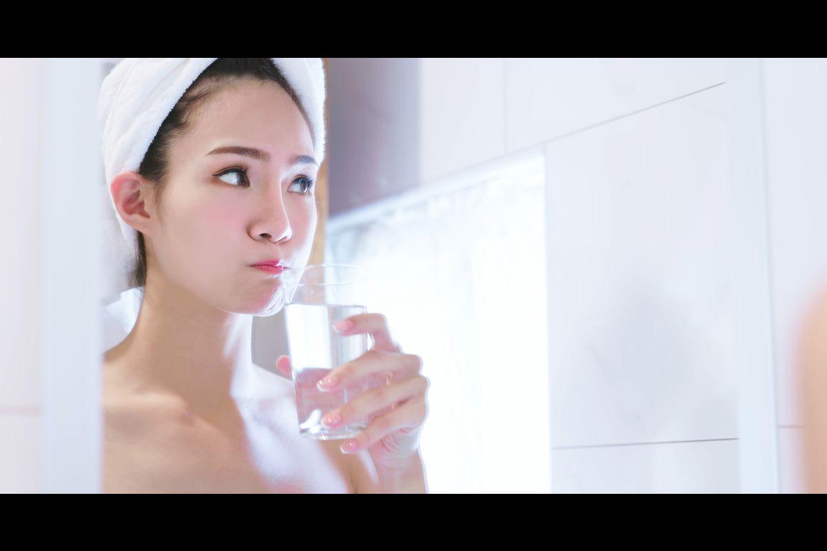 Woman rinsing out her mouth at the sink