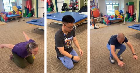 A group of employees attempt to jump up from kneeling