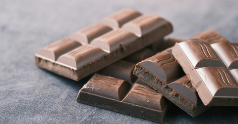 Unwrapped chocolate bars sit on the counter
