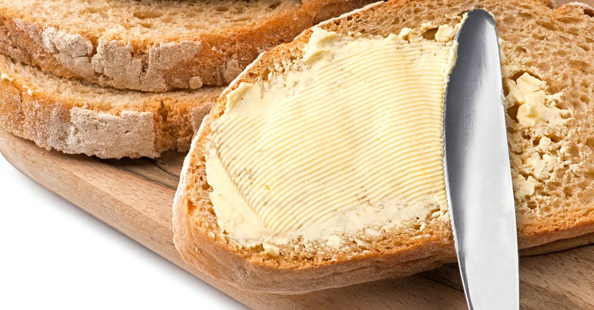 vegan butter spread on sourdough bread with a knife