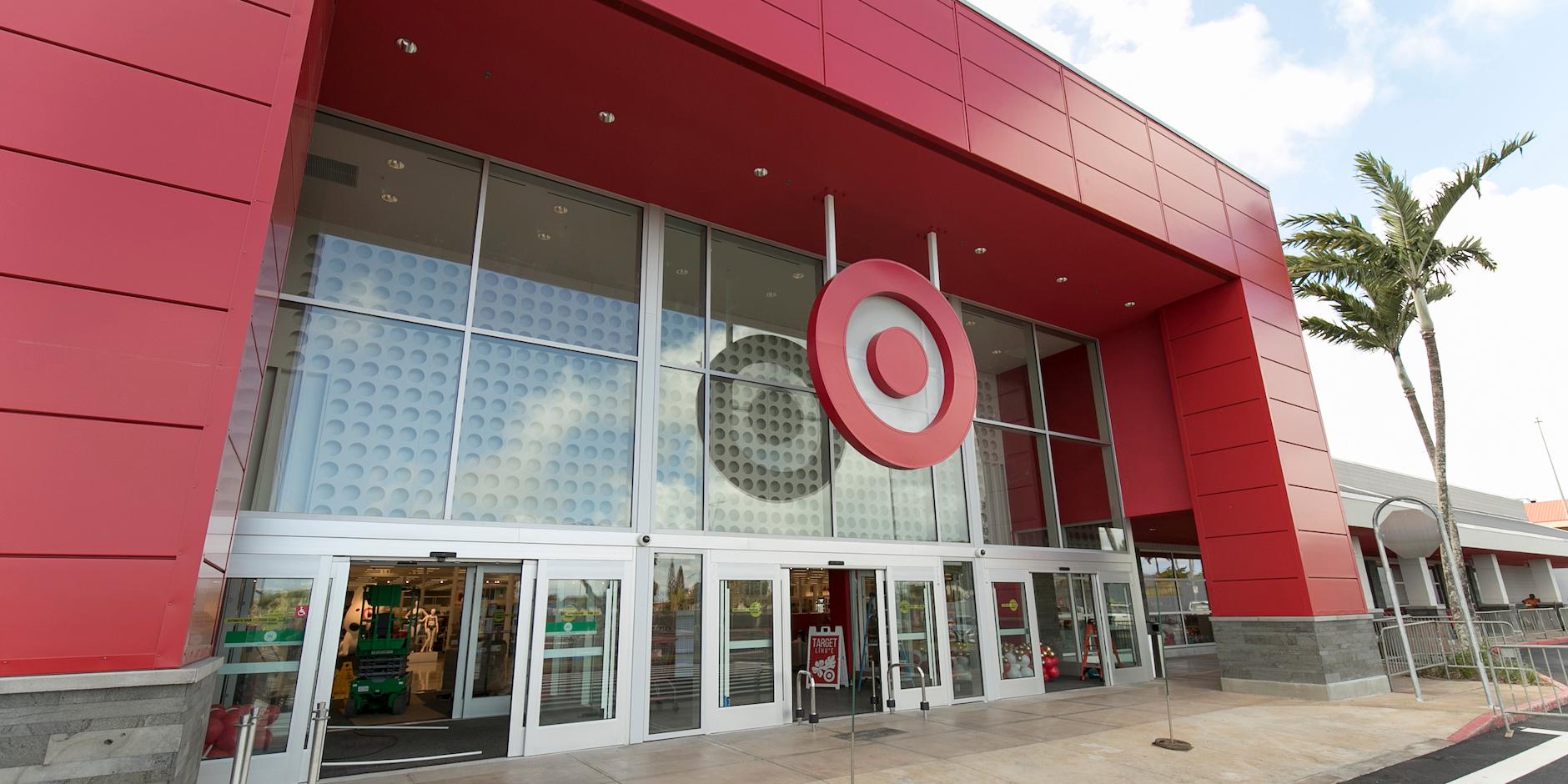A Target store is pictured beside a tree in a shopping center.