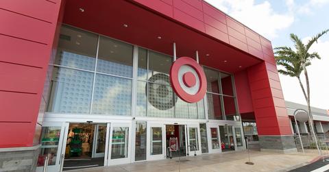 A Target store is pictured beside a tree in a shopping center.