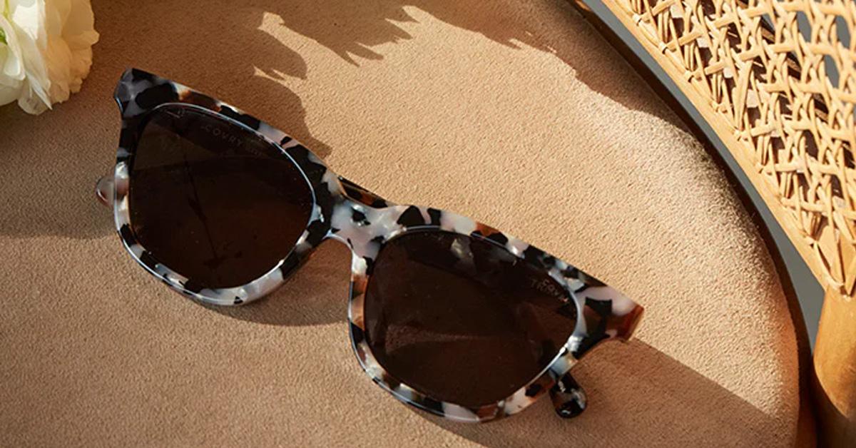 Covry Trix Stone Sunglasses in tortoise shell sit on a seat cushion