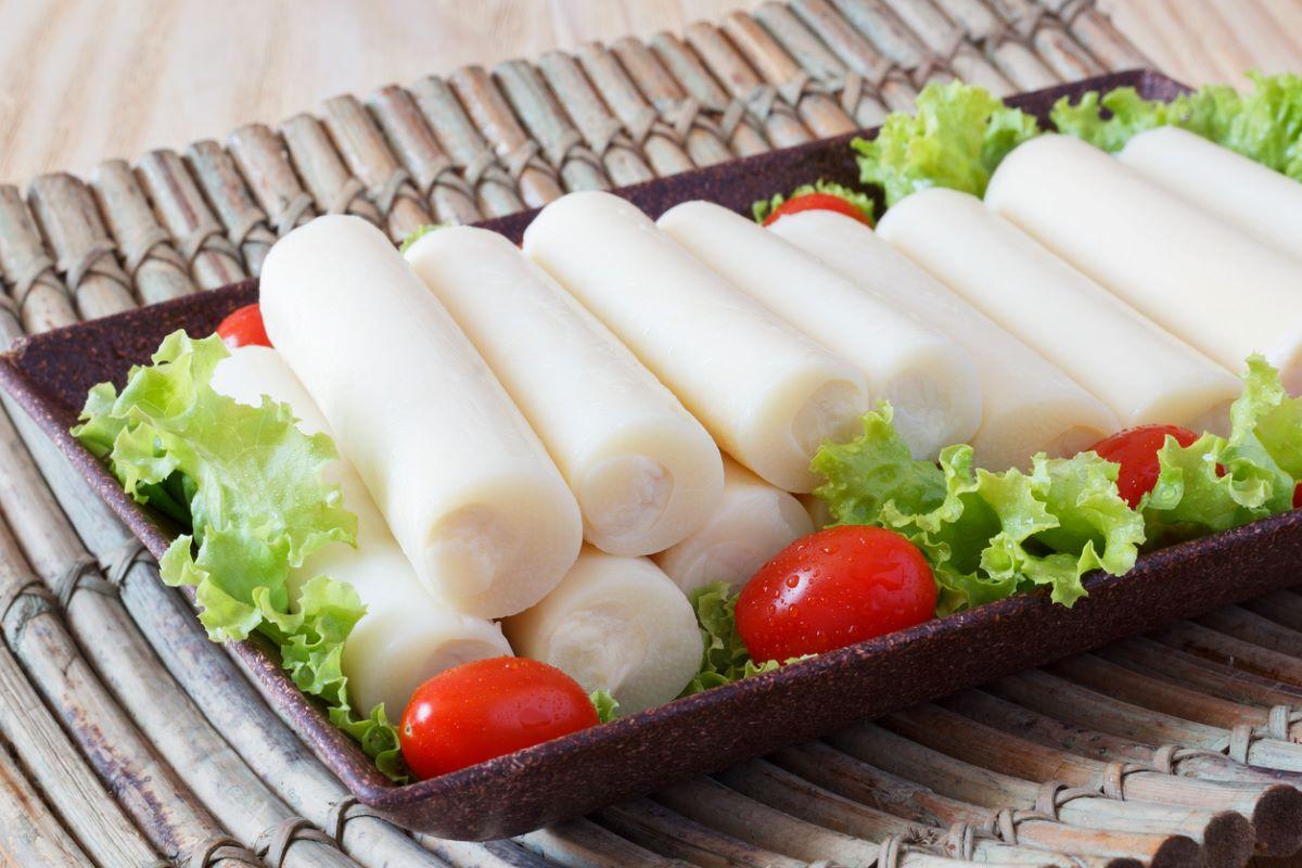 Hearts of palm with cherry tomatoes and lettuce on a rectangular plate