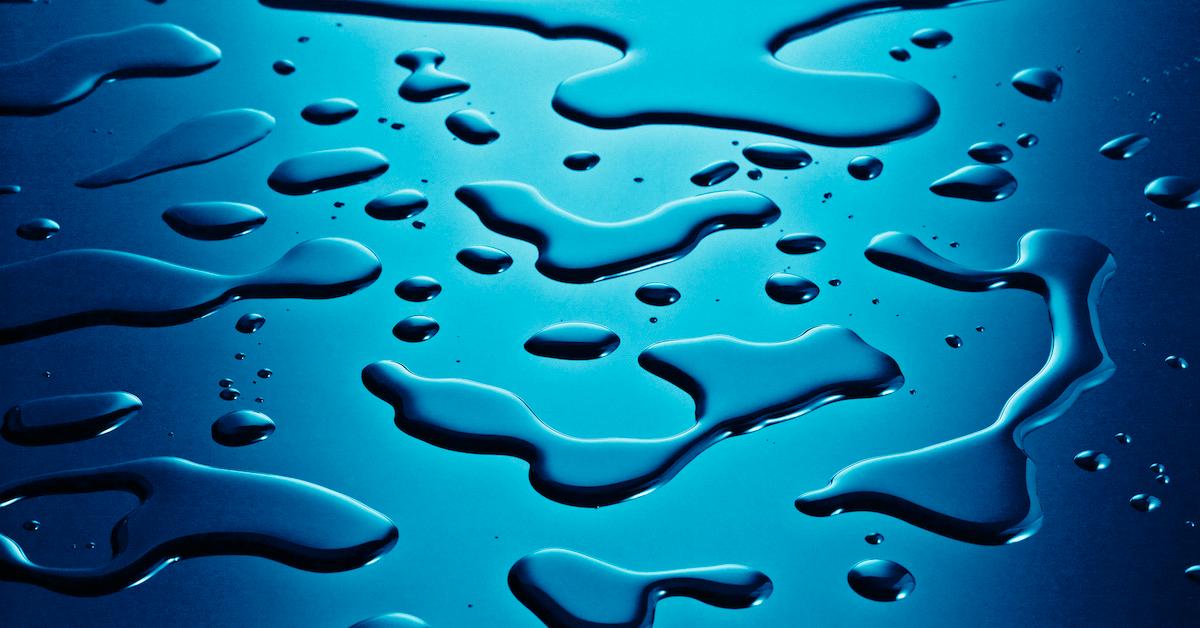 Closeup of drops of water on a blue surface