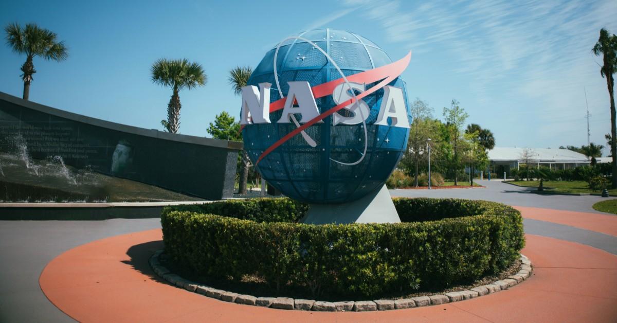 A replica of the earth with the word NASA across it sits in a courtyard