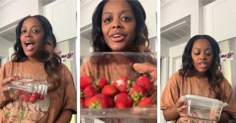 woman shows moldy strawberries and glass container