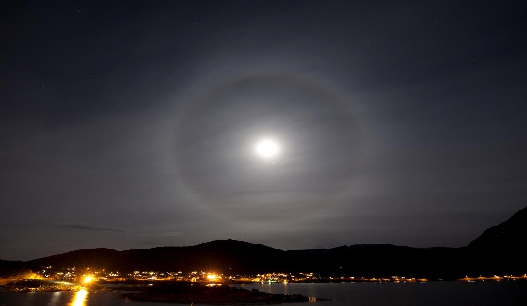 A ring or halo around the moon over the city of TromsA in arctic Norway