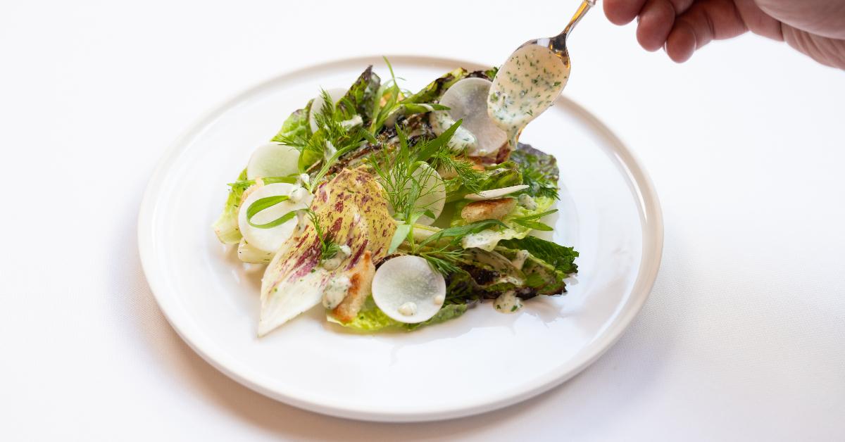 Photo of chef drizzling a dressing on a dish made with the EVERY Company's EVERY Egg