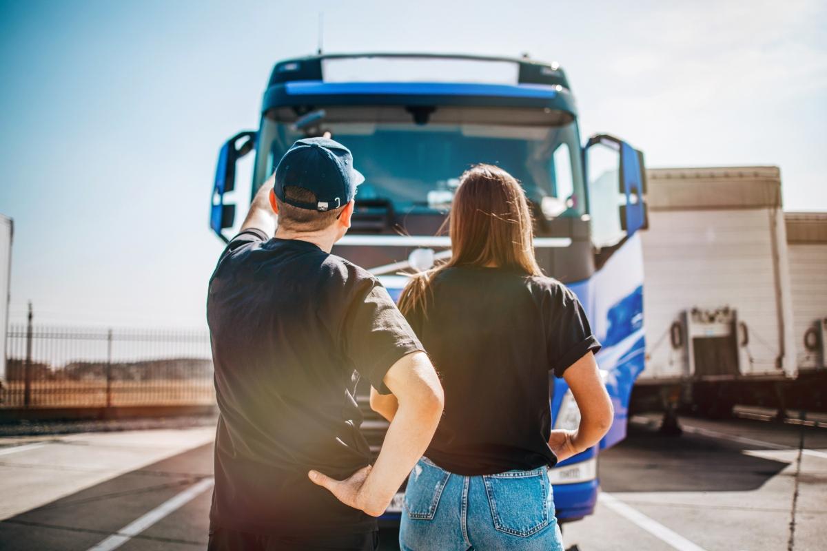 two people looking at large commercial truck