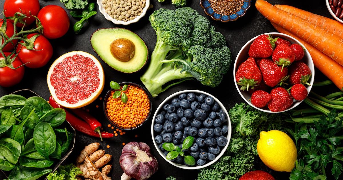 Various fruits and veggies on a table, photographed from above