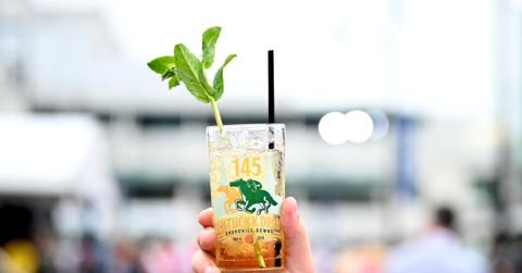 Man holding a mint julep at the Kentucky Derby