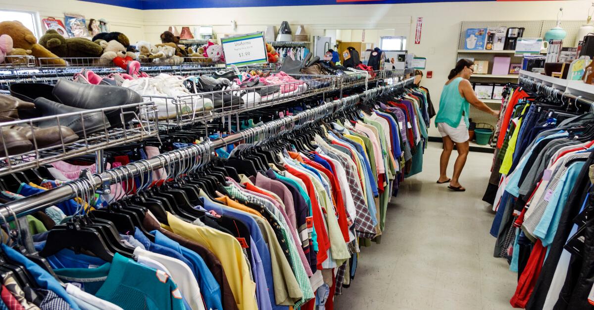 Photo of a woman perusing racks in a Goodwill thrift store 