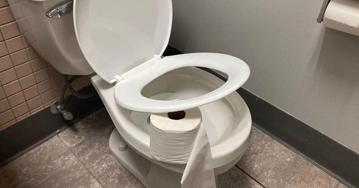 Toilet paper roll under toilet seat