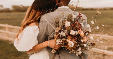 Photo of man and woman on their wedding day taken from behind