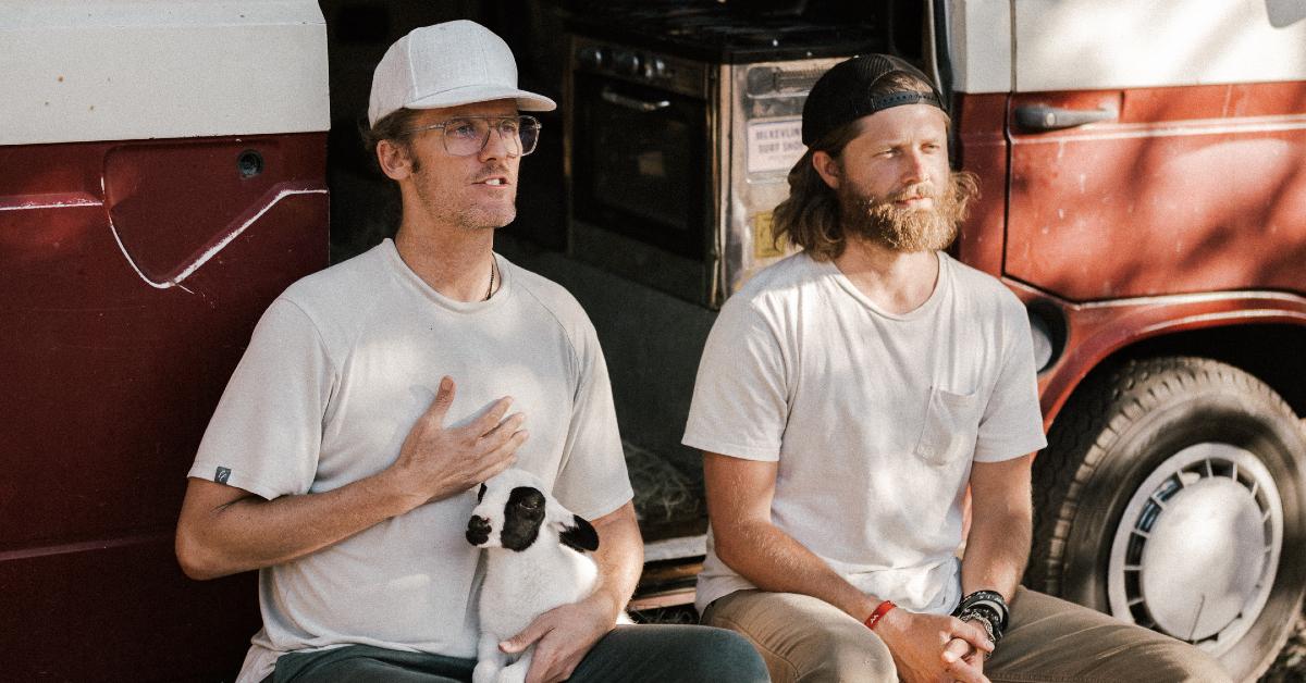 Photo of filmmakers Kip Andersen and Kameron Waters holding a baby goat 