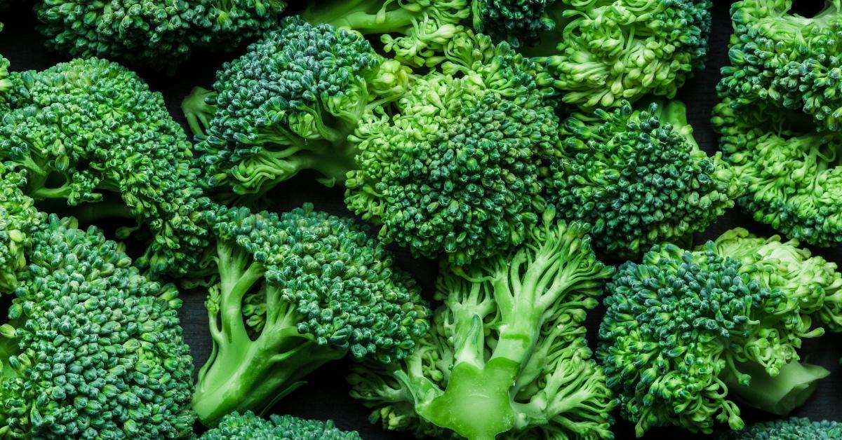 A close-up photograph of a pile of broccoli florets.