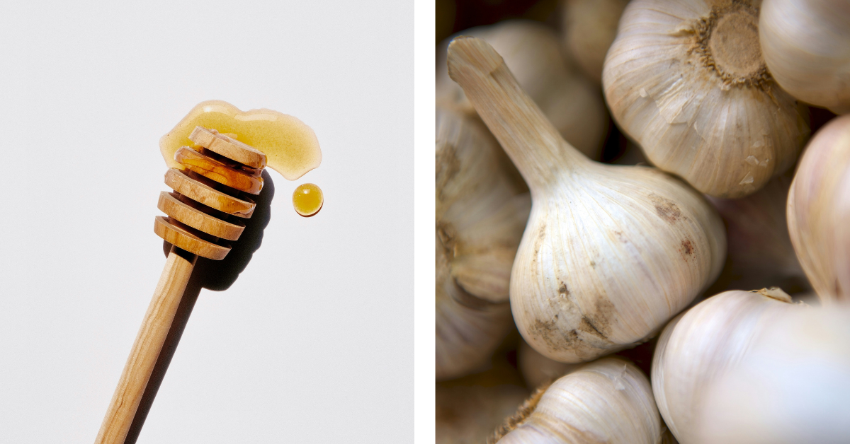 A splash of honey and a few garlic bulbs piled together