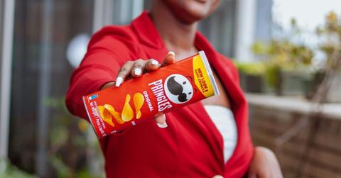 A woman holding an original flavor Pringles tube (Representative Cover Image Source: Unsplash | Proper Quality Shandis)