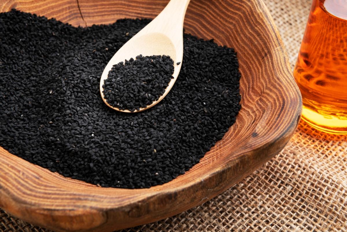 Black seeds in a wooden bowl