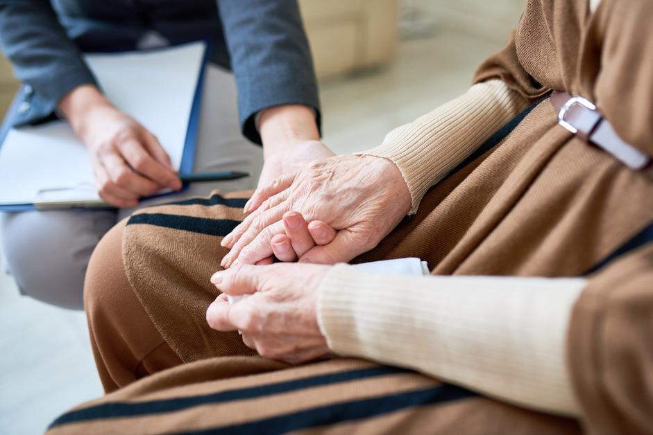 A senior patient being comforted by doctor. 