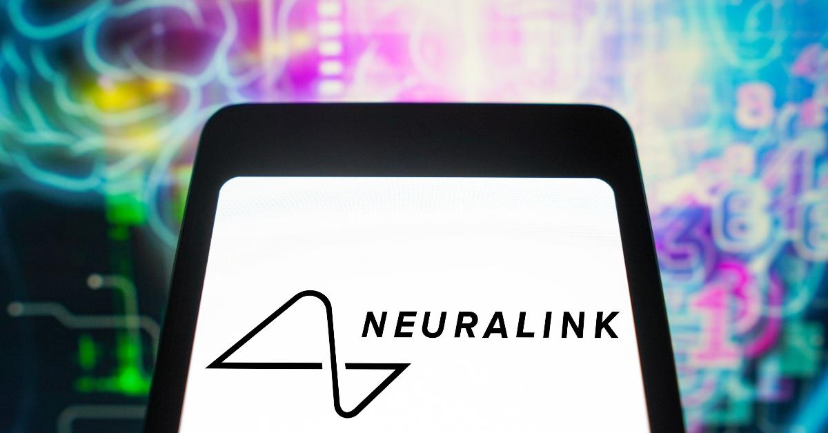 Neuralink logo on a tablet with bright designs in the background. 