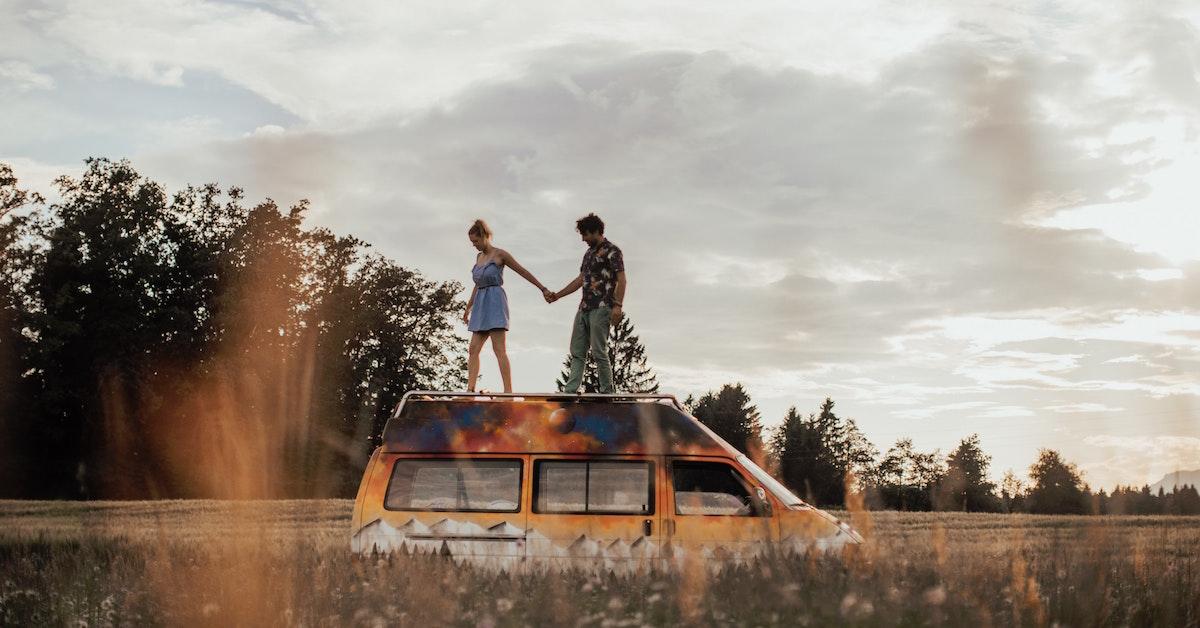 Vanlife couple parked in a field