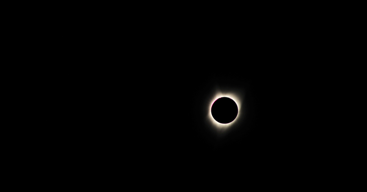 The sun appears white against the blacked out moon during a ring of fire eclipse