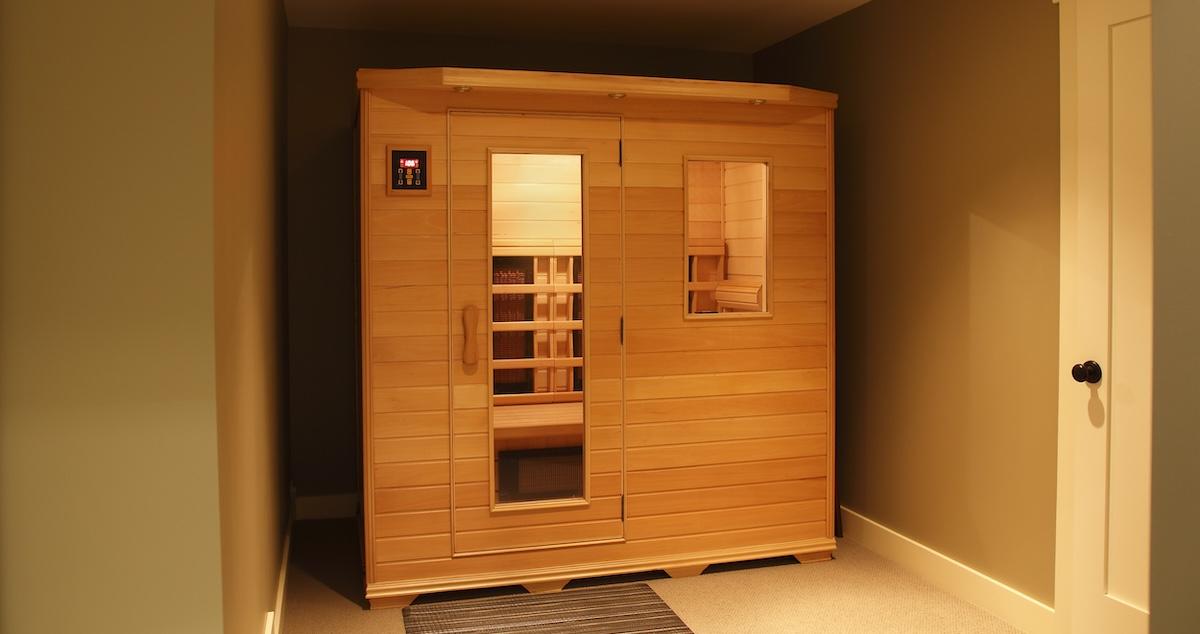 Small wooden infrared sauna inside home stock photo