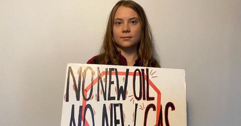 greta thunberg holding a protest sign