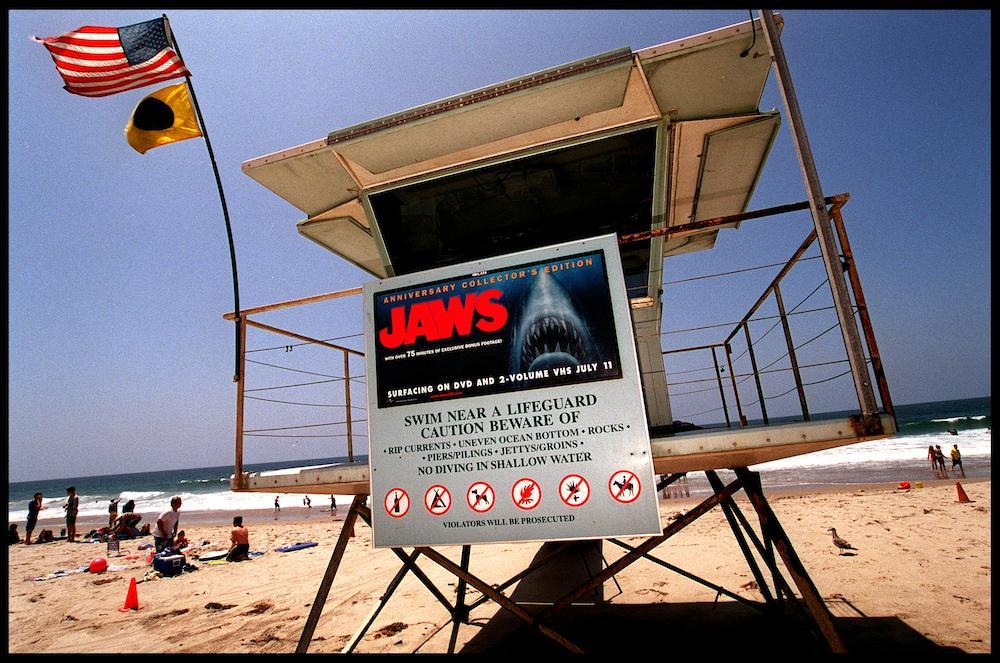 A "Jaws" movie poster displayed at a beach.