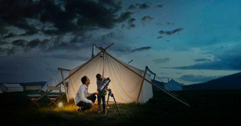 Father and child are looking through a telescope. (Representative Cover Image Source: Getty Images | Dana Neibert)