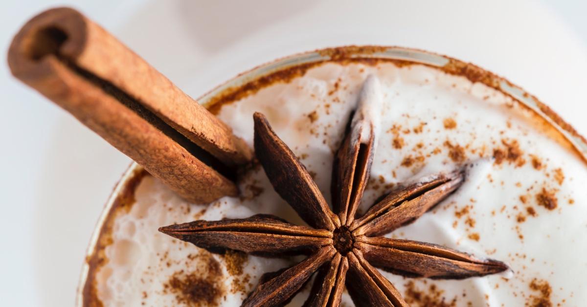 Foamy drink with cinnamon stick.