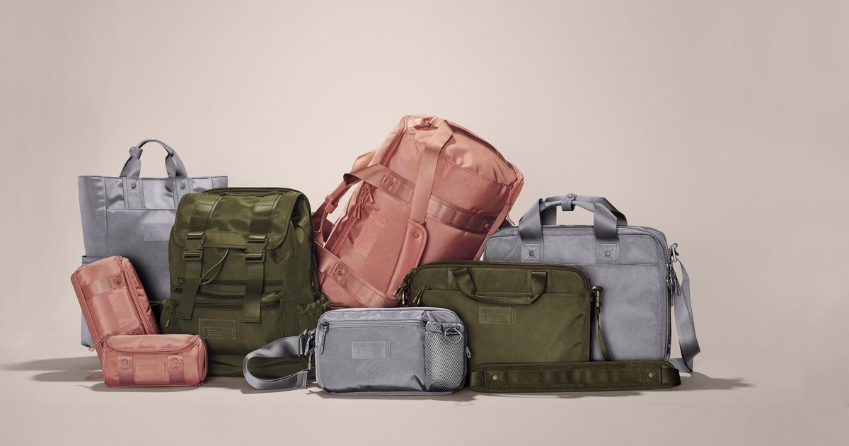 Various Dagne Dover bags on tan background