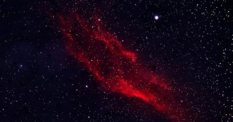 A crimson-red galaxy glowing with stars and bright celestial objects (Representative Cover Image Source: Pexels | Simplyart3794)