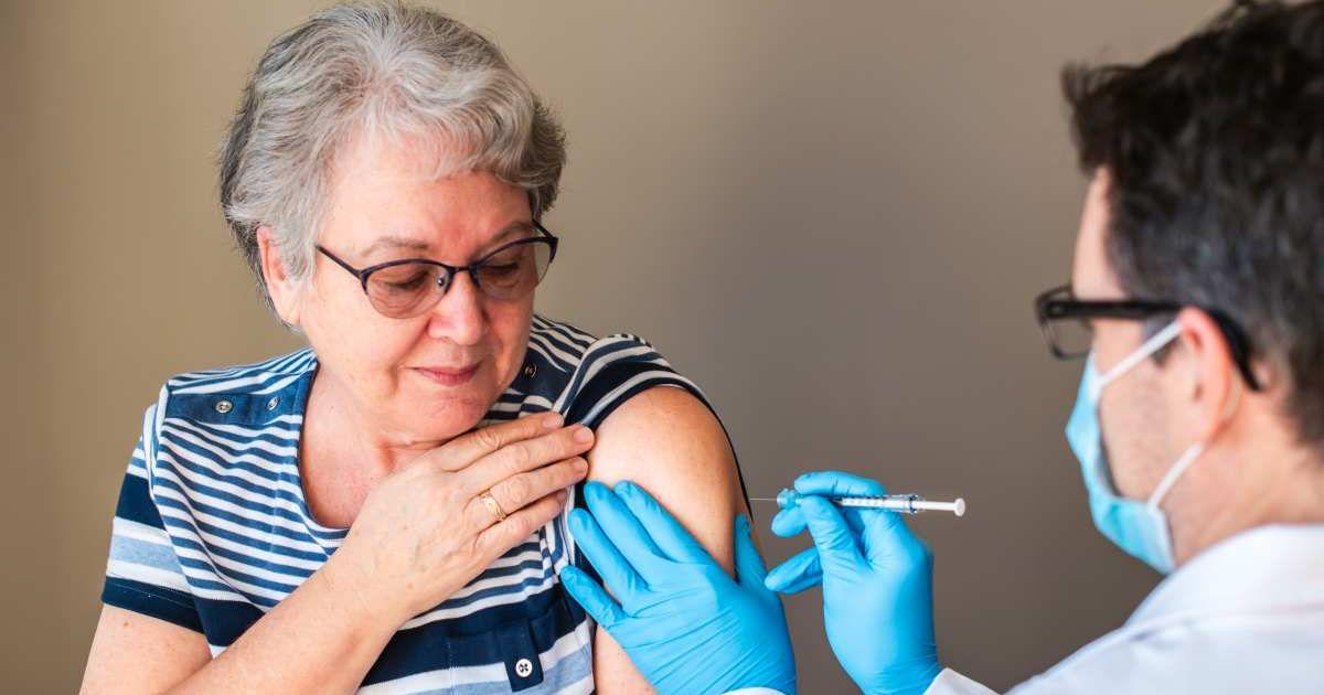 An older woman is getting injected with a vaccine by a doctor in her upper arm. (Representative Cover Image Source: Getty Images | Cavan Images)