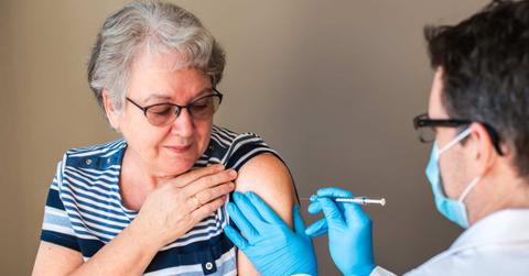An older woman is getting injected with a vaccine by a doctor in her upper arm. (Representative Cover Image Source: Getty Images | Cavan Images)