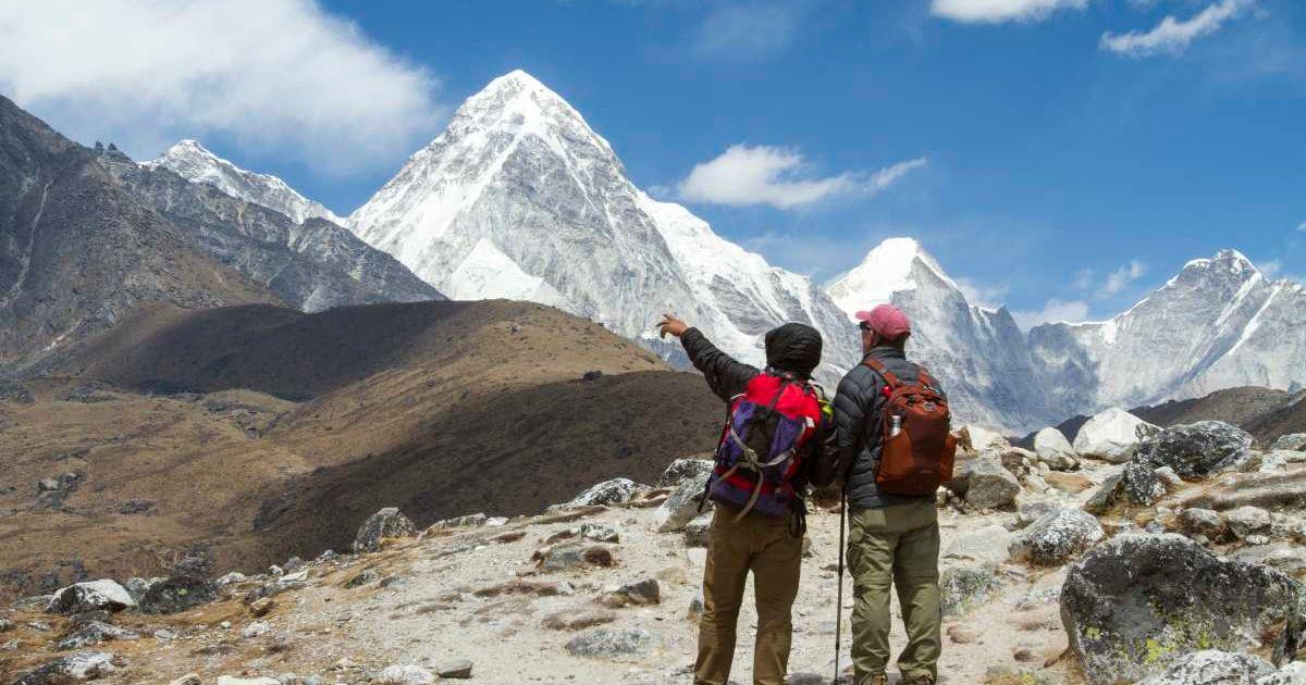 Two trekkers looking at the iceless peaks of Mt. Everest. (Representative Cover Image Source: Getty Images | Nick Pederson)