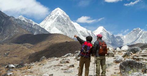 Two trekkers looking at the iceless peaks of Mt. Everest. (Representative Cover Image Source: Getty Images | Nick Pederson)