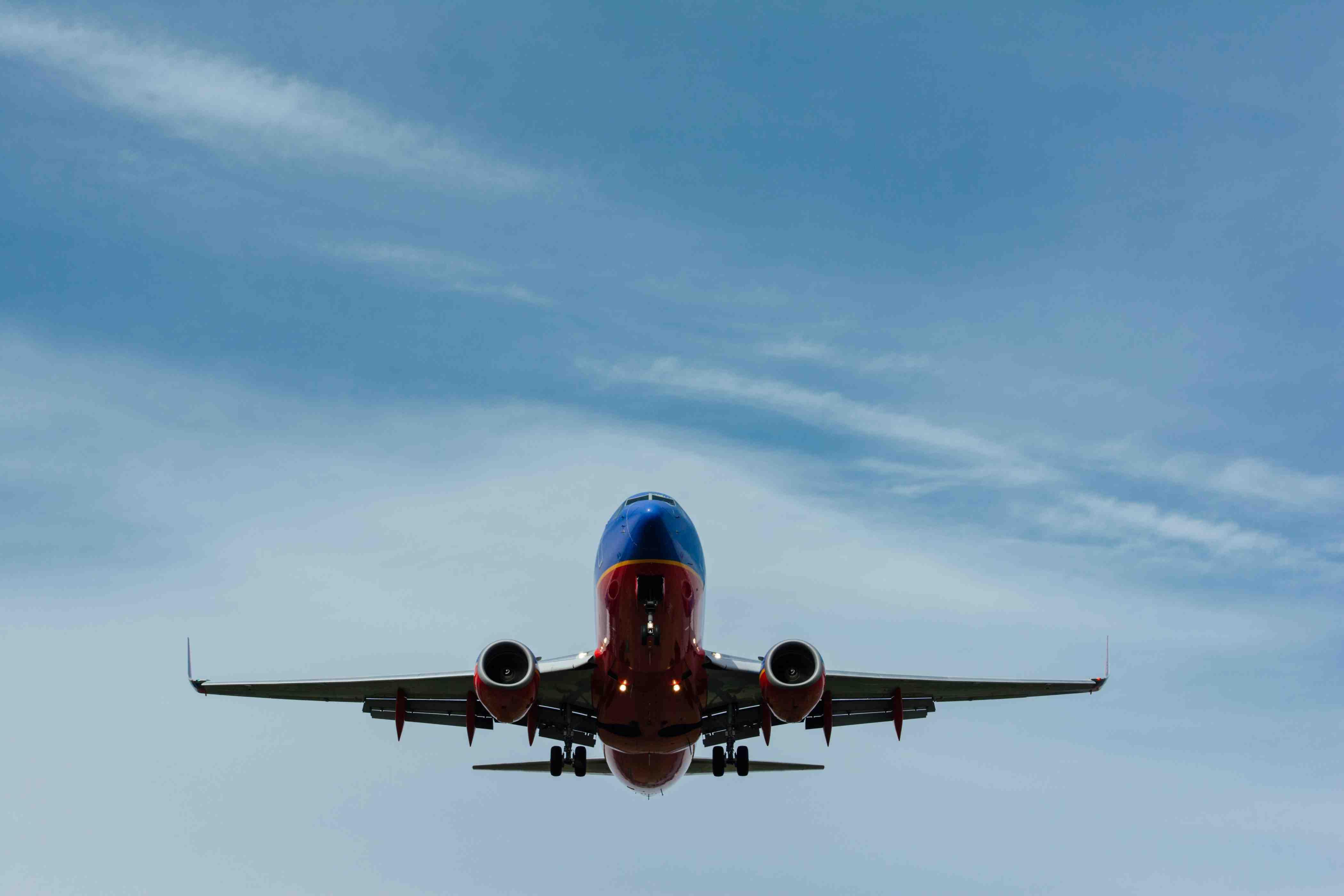 A plane is pictured flying through the cloudy sky.