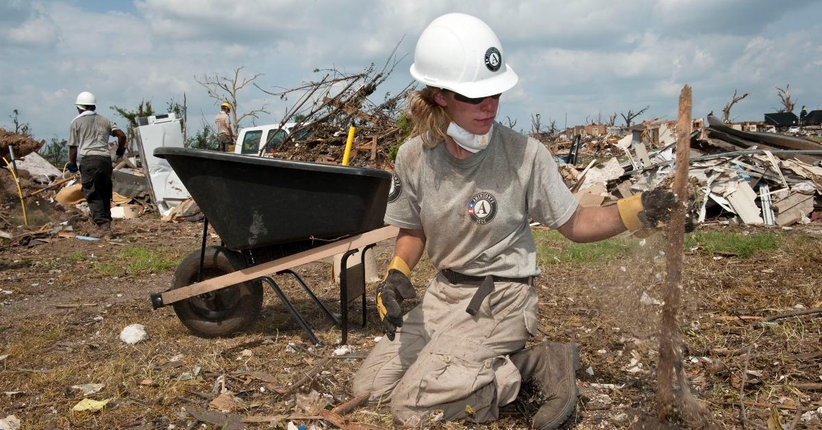 An AmeriCorps worker cleaning up after a hurricane. 