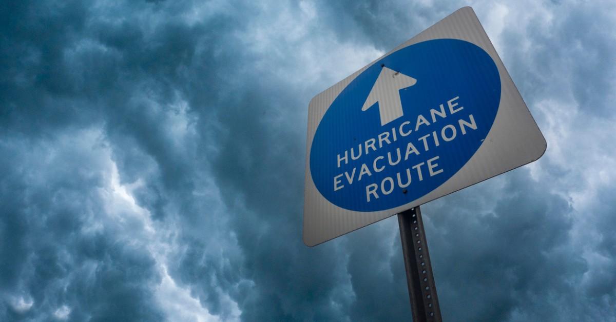 A hurricane evacuation route sign stands out against a stormy sky