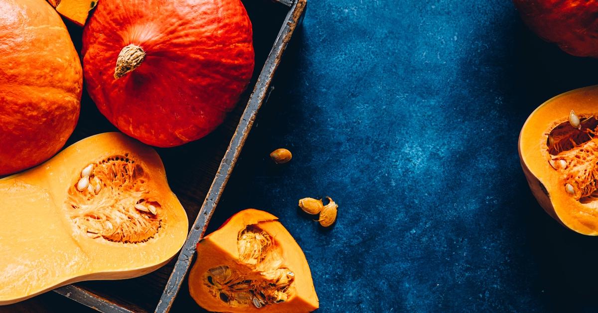 Pumpkins and squash cut up and put in pans. 